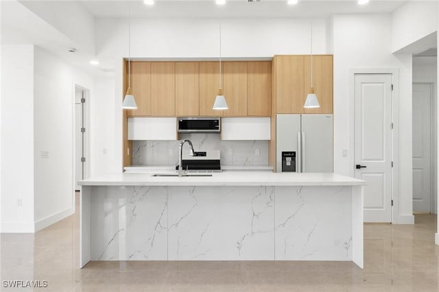 kitchen with tasteful backsplash, a kitchen island with sink, sink, white refrigerator with ice dispenser, and white cabinetry