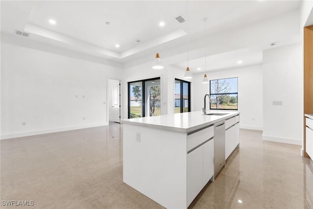 kitchen with white cabinets, a kitchen island with sink, a healthy amount of sunlight, and sink