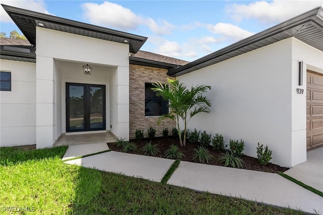 property entrance featuring french doors and a garage