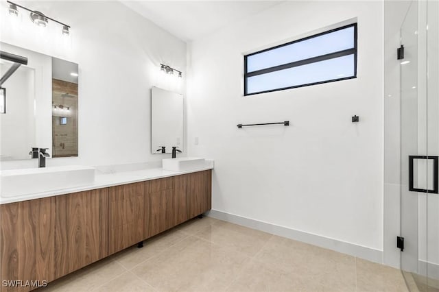 bathroom featuring tile patterned flooring, vanity, and a shower with shower door