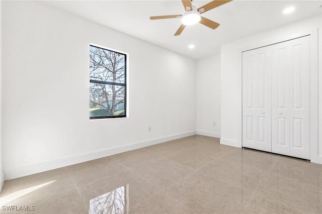 unfurnished bedroom with ceiling fan and a closet