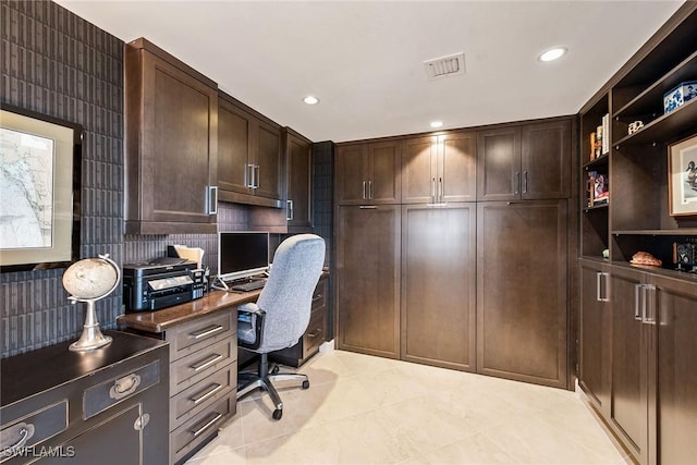 home office featuring built in desk and light tile patterned floors