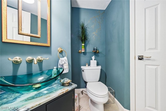 bathroom featuring tile patterned floors, vanity, and toilet