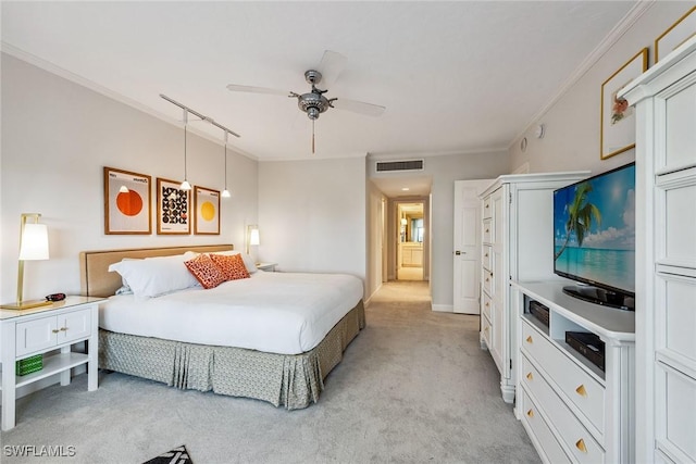 carpeted bedroom with ceiling fan and ornamental molding