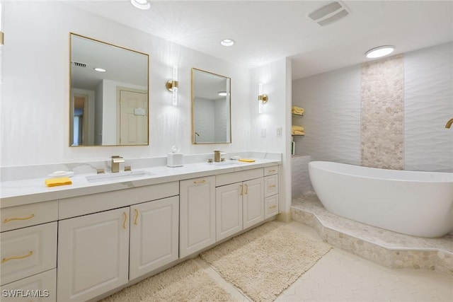 bathroom with a washtub and vanity