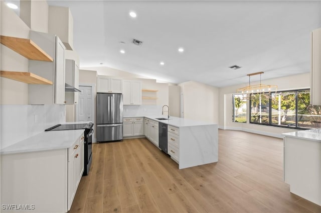 kitchen with white cabinetry, kitchen peninsula, stainless steel appliances, backsplash, and pendant lighting