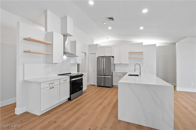 kitchen featuring white cabinets, appliances with stainless steel finishes, wall chimney exhaust hood, lofted ceiling, and sink