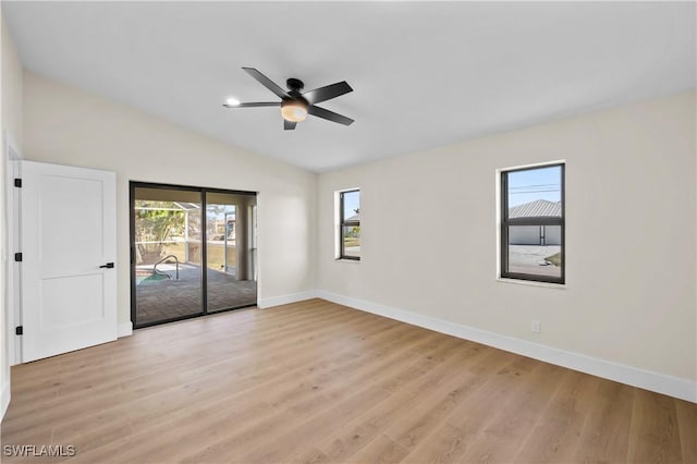 spare room featuring light hardwood / wood-style floors, ceiling fan, and a healthy amount of sunlight