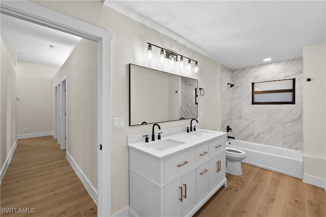 full bathroom with toilet, tiled shower / bath combo, and vanity