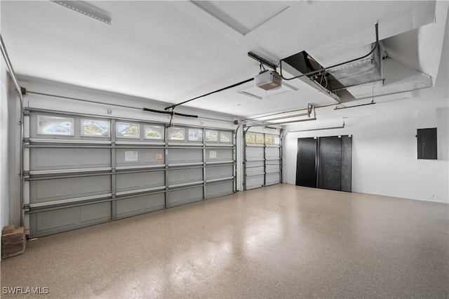 garage with electric panel and a garage door opener