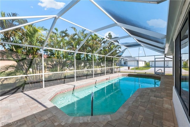 view of swimming pool featuring a patio area and glass enclosure