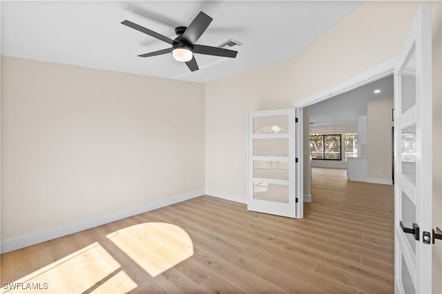 empty room featuring hardwood / wood-style flooring and ceiling fan