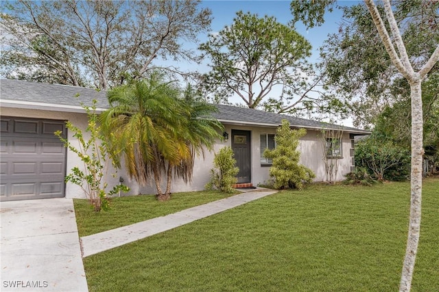 ranch-style house featuring a garage and a front yard