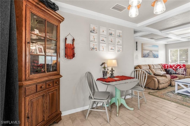 dining space featuring beam ceiling and coffered ceiling