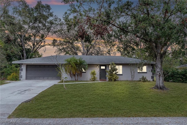 single story home with a yard and a garage