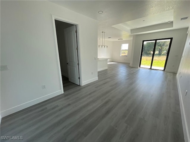 unfurnished living room featuring dark wood-type flooring