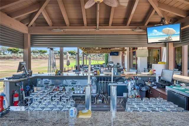 view of patio featuring a gazebo, ceiling fan, and a bar