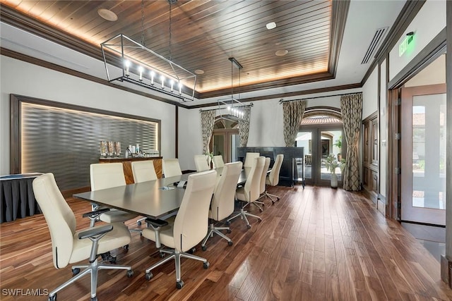 dining space featuring french doors, an inviting chandelier, dark hardwood / wood-style flooring, a tray ceiling, and wood ceiling