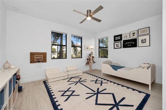 bedroom with hardwood / wood-style floors and ceiling fan