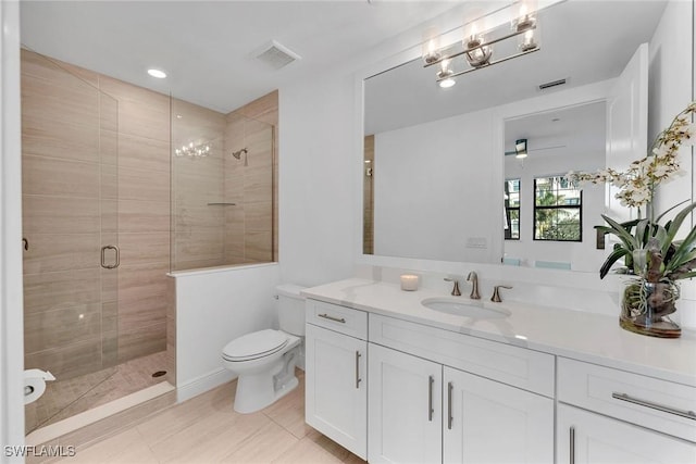 bathroom featuring walk in shower, vanity, ceiling fan, tile patterned flooring, and toilet