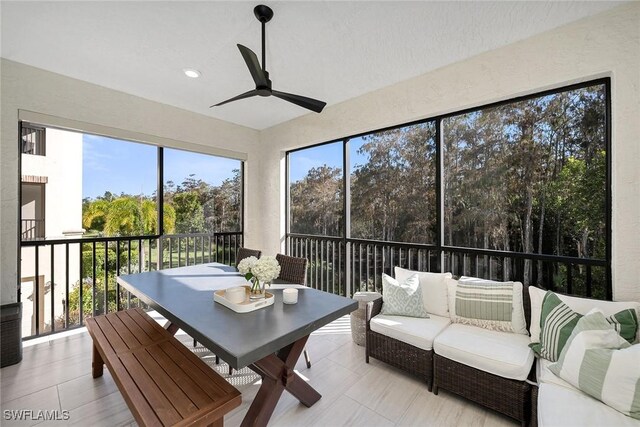 sunroom / solarium featuring ceiling fan