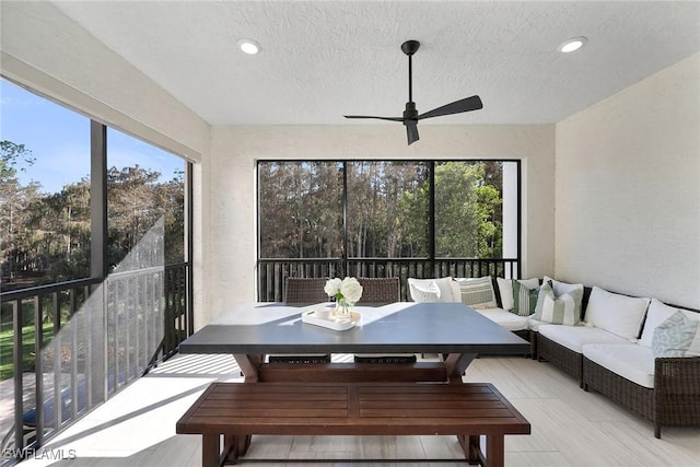 sunroom with ceiling fan and plenty of natural light