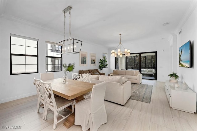 dining room with a chandelier and ornamental molding