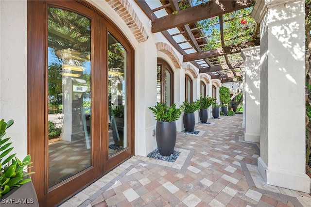 view of patio / terrace with french doors and a pergola