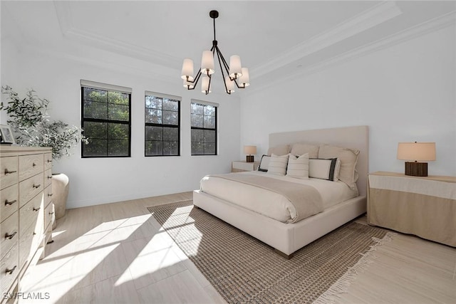 bedroom with a raised ceiling, crown molding, light hardwood / wood-style flooring, and a chandelier