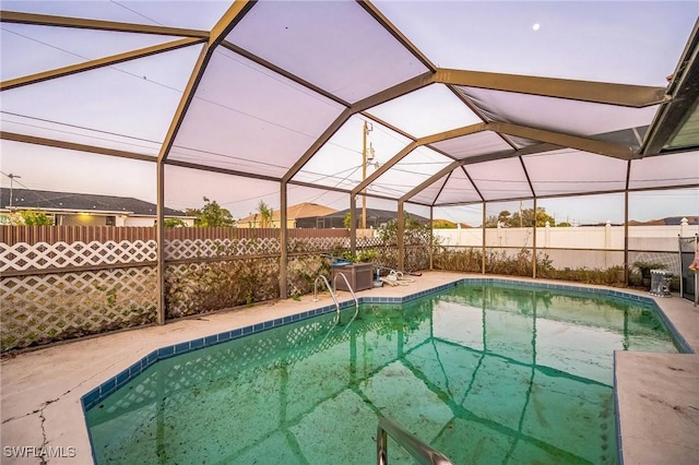 view of pool with glass enclosure