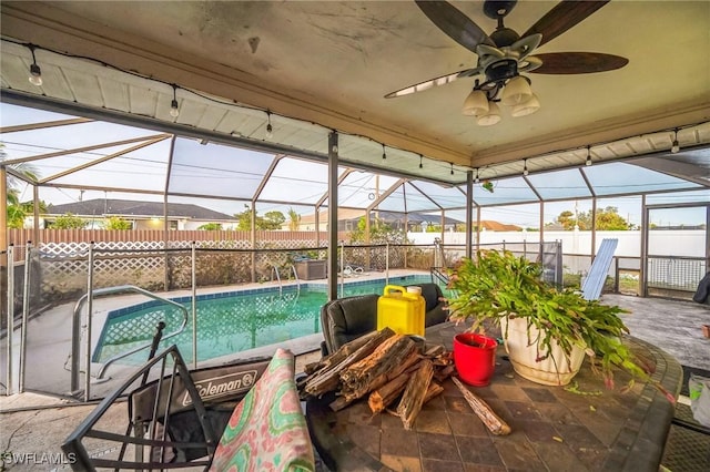 view of pool with a lanai, a patio area, and ceiling fan