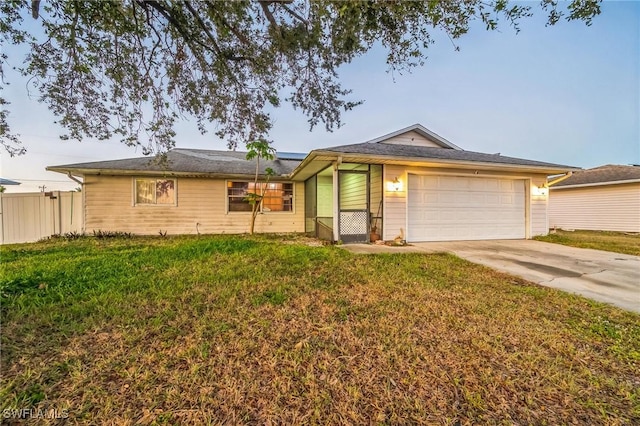 ranch-style house featuring a front yard and a garage