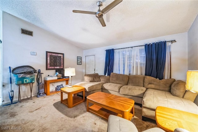 carpeted living room featuring a textured ceiling, ceiling fan, and vaulted ceiling