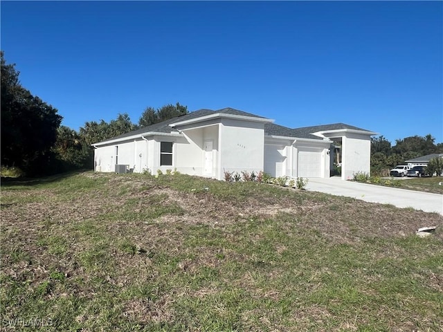 view of front facade with a garage and cooling unit