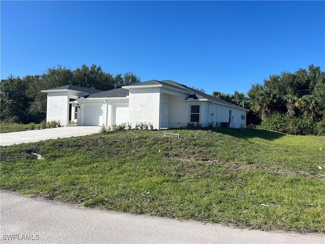 view of front of property with a front yard and a garage