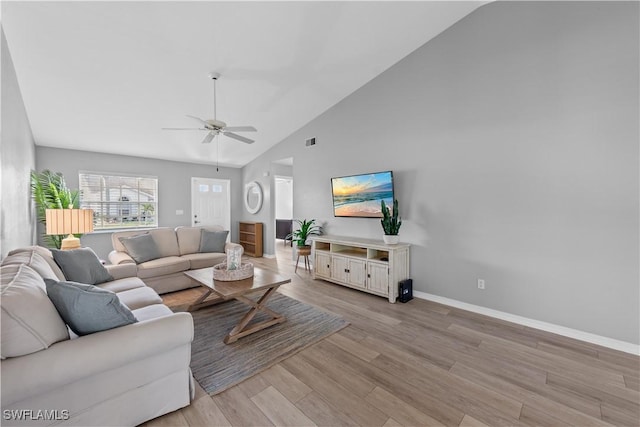 living room with high vaulted ceiling, ceiling fan, and light hardwood / wood-style flooring