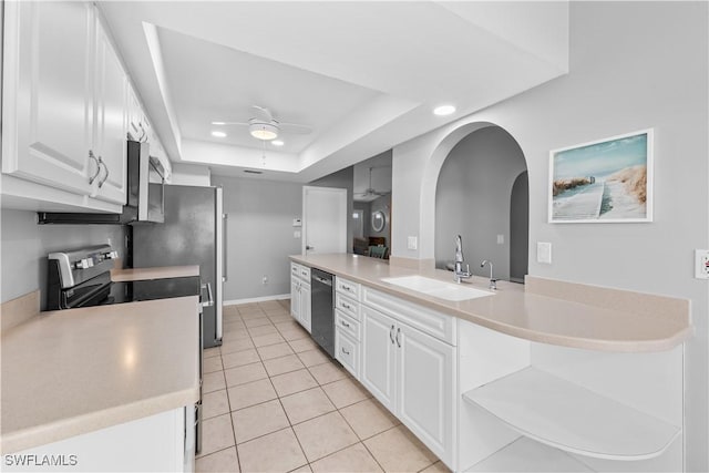 kitchen featuring sink, a tray ceiling, stainless steel appliances, and white cabinets