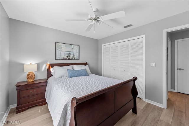 bedroom featuring light hardwood / wood-style floors, a closet, and ceiling fan