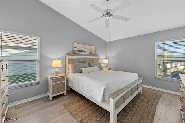 bedroom with ceiling fan, lofted ceiling, and light wood-type flooring