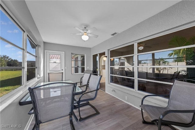 sunroom / solarium featuring ceiling fan