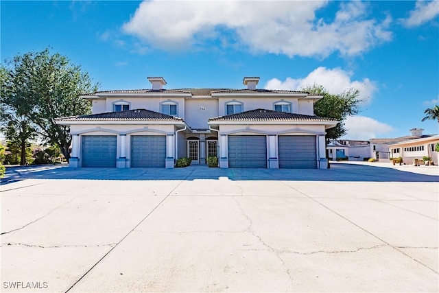 mediterranean / spanish home featuring a garage