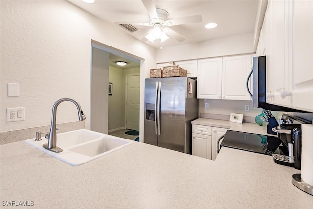 kitchen featuring white cabinets, appliances with stainless steel finishes, ceiling fan, and sink