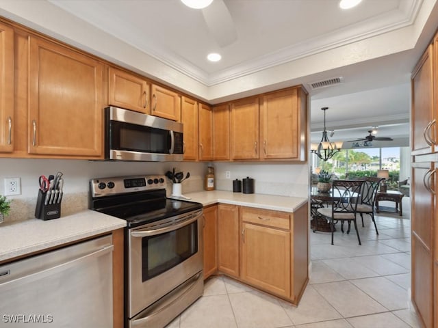 kitchen with crown molding, ceiling fan, light tile patterned floors, decorative light fixtures, and stainless steel appliances