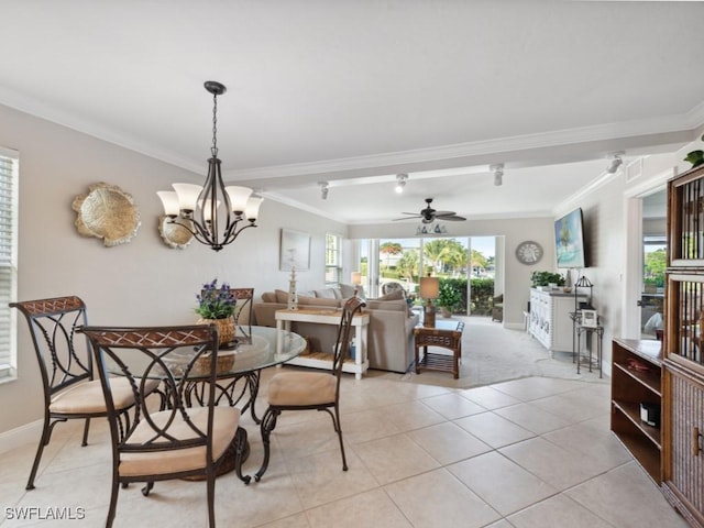 tiled dining room with ceiling fan with notable chandelier and crown molding