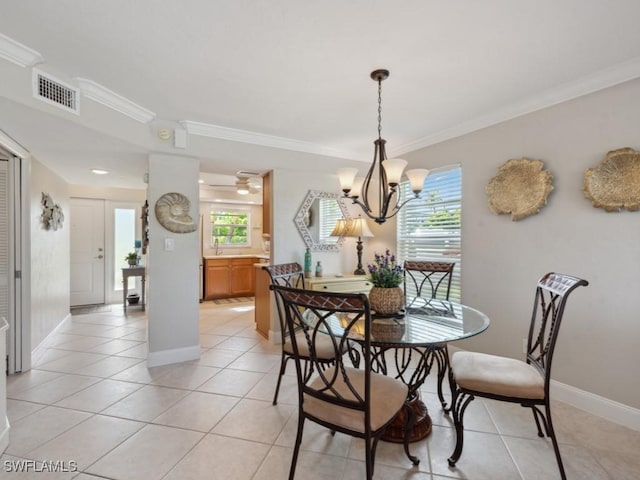 tiled dining space featuring a notable chandelier, plenty of natural light, and ornamental molding