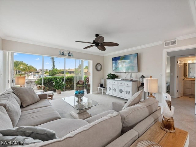 living room featuring ceiling fan, light tile patterned flooring, and crown molding