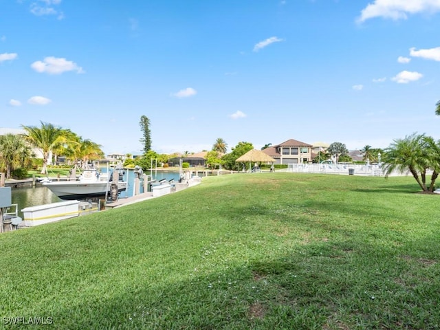 view of yard with a dock and a water view