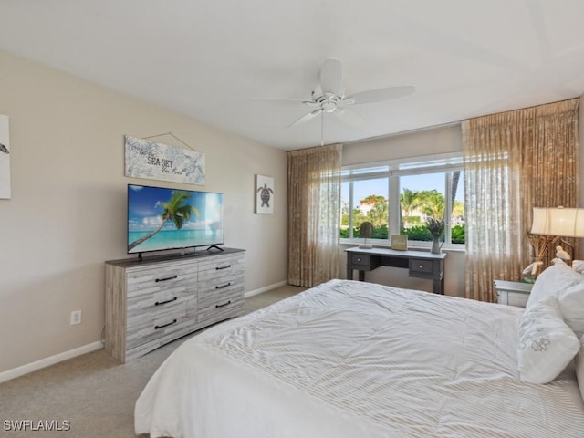 bedroom featuring ceiling fan and light carpet