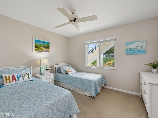 bedroom featuring light carpet and ceiling fan