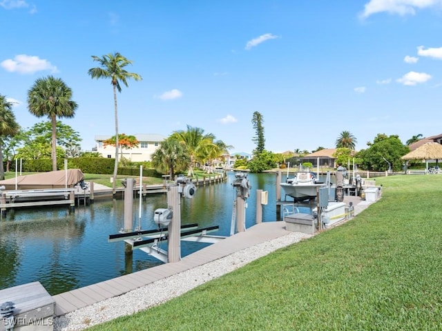 view of dock featuring a water view and a lawn